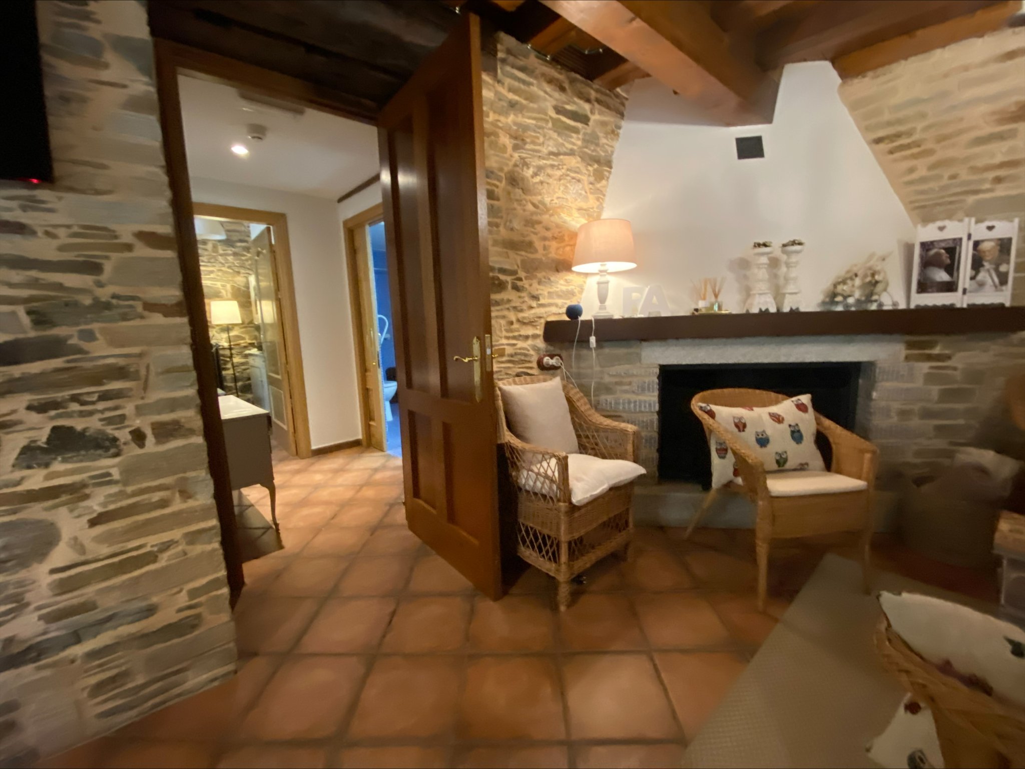 Stone fireplace sitting room at No Pasa Nada Albergue