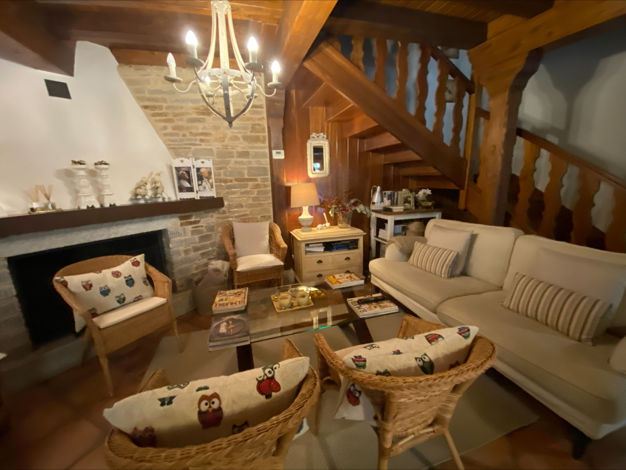 Cozy common room with fireplace and chandelier at No Pasa Nada Albergue
